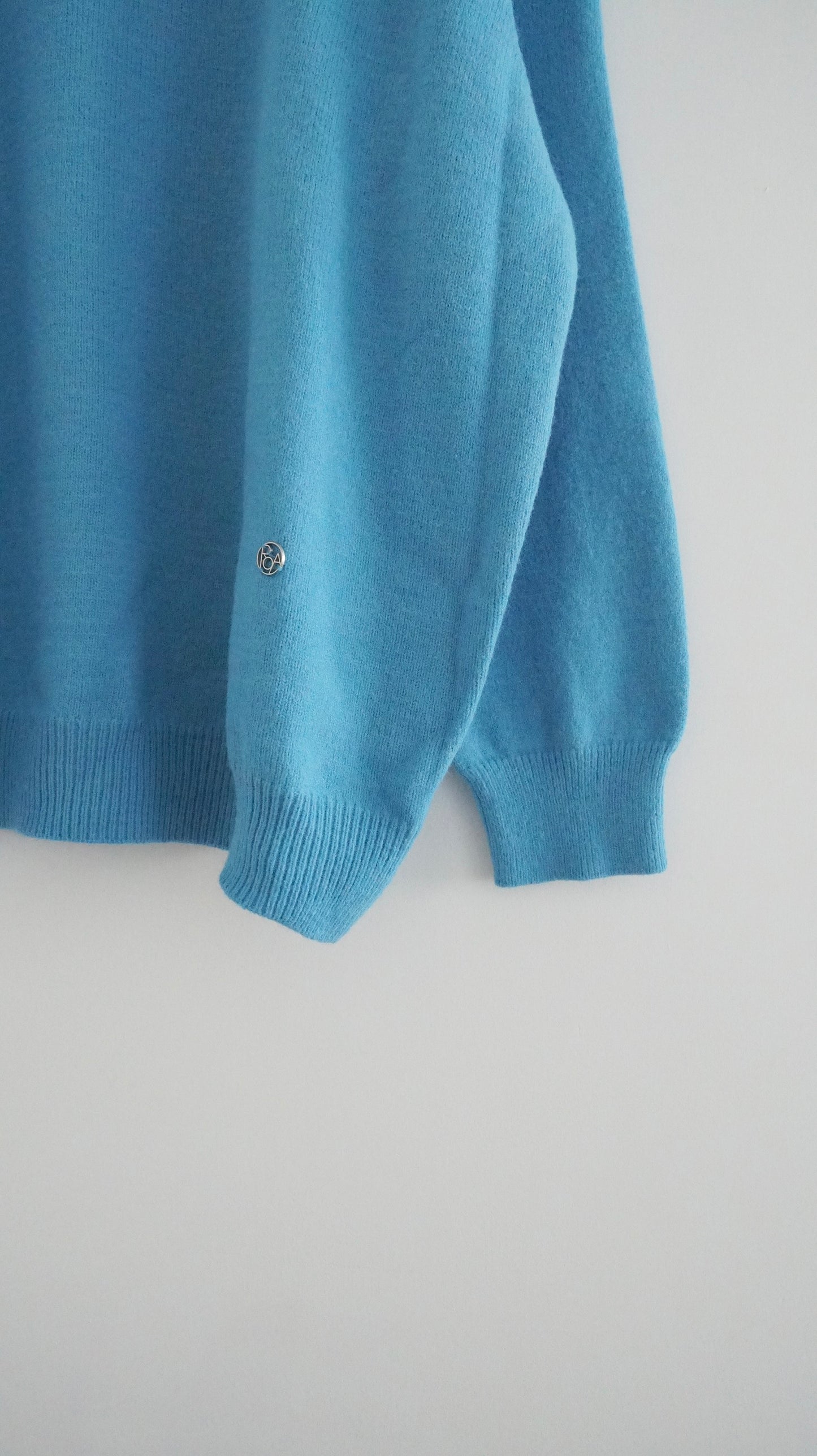 classic gender free v-neck wool sweater in lake blue