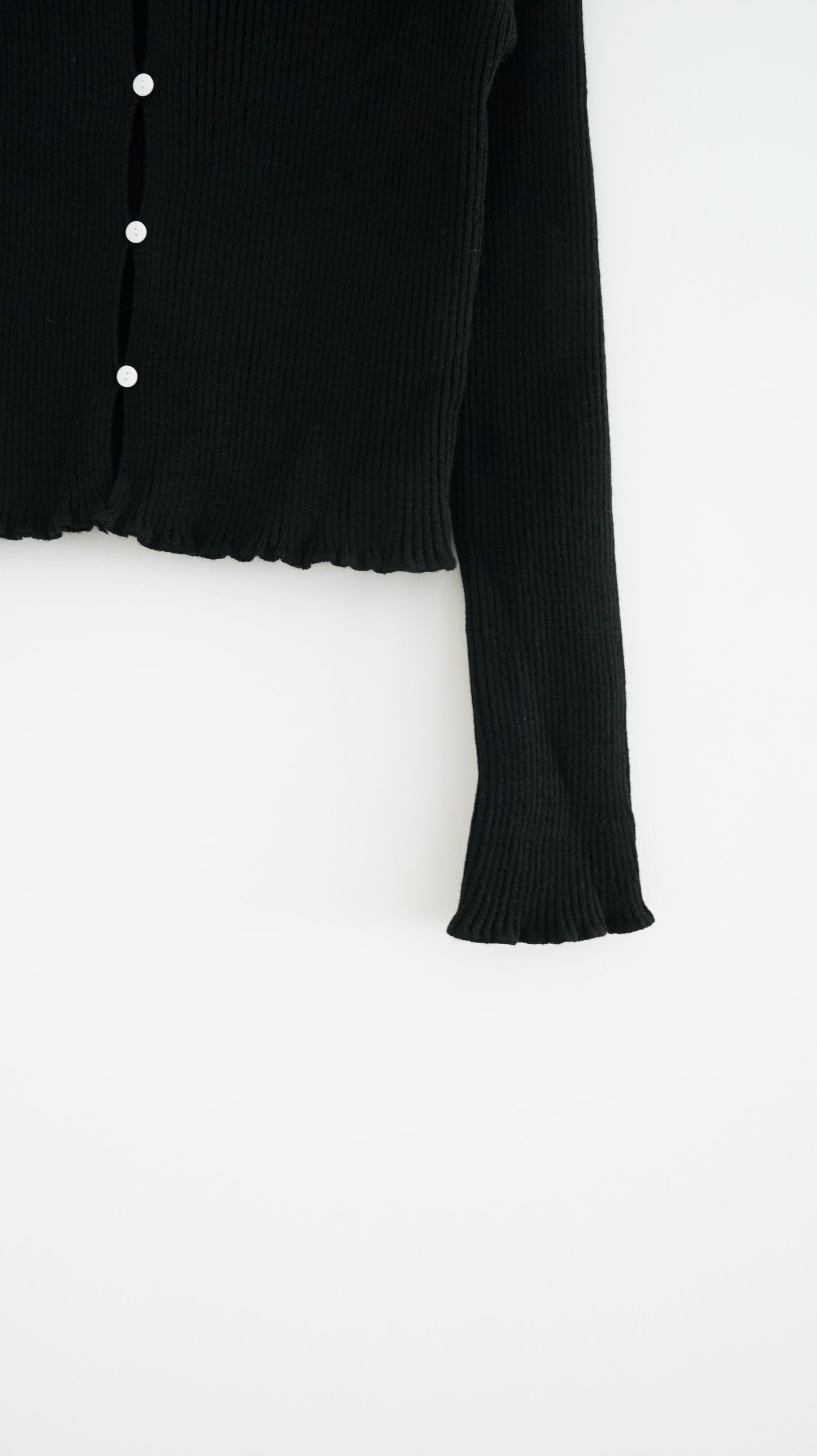 the elodie ruffle cardigan in black